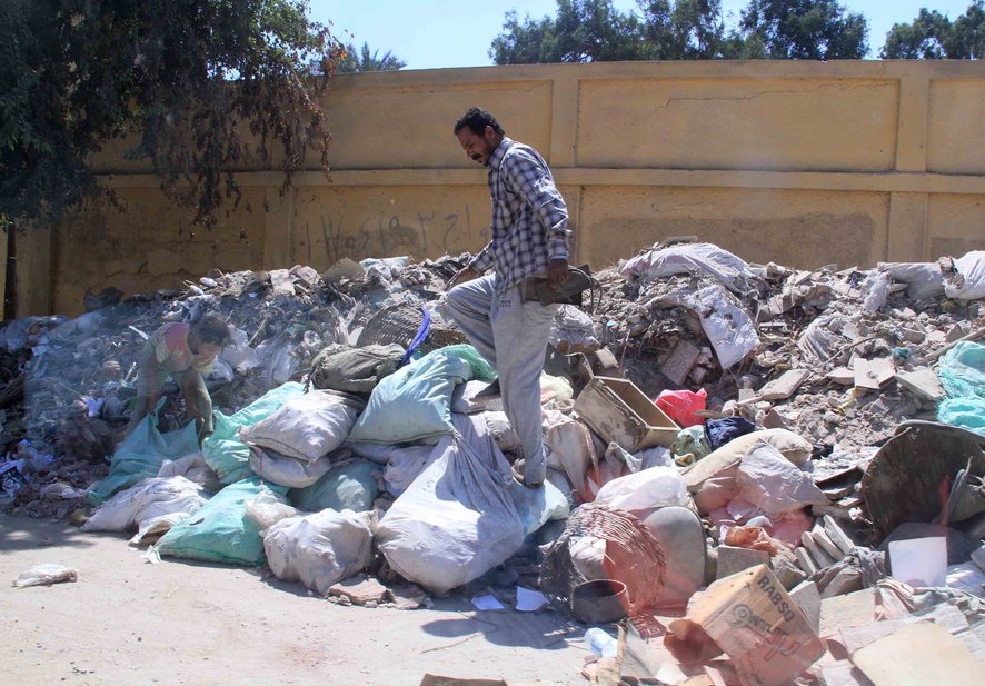 A man work to collect trash as part of Morsy’s ‘Clean Homeland’ campaign