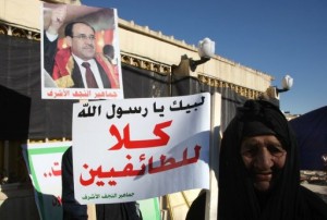 An Iraqi woman holds a sign reading: "no the sectarianism," during a demonstration in Najaf (AFP Photo / Qassem Zein)